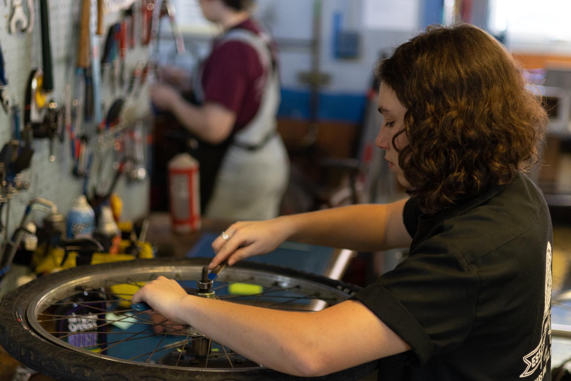 Bike Barn Mechanic Adjusting a Hub